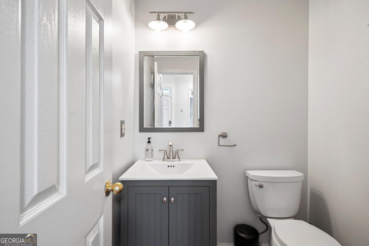 1229 Crescentwood Lane Decatur, GA 30032 - Photo 22 of 25 a bathroom with a toilet sink and mirror
