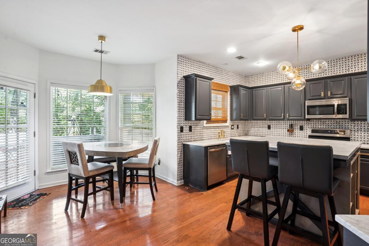 1229 Crescentwood Lane Decatur, GA 30032 - Photo 6 of 25 a kitchen with a dining table chairs and refrigerator