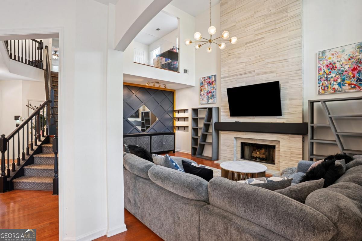 1229 Crescentwood Lane Decatur, GA 30032 - Photo 8 of 25 a living room with furniture a fireplace and a flat screen tv
