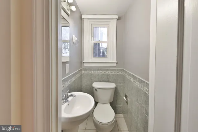 a white toilet sitting next to a bathroom sink