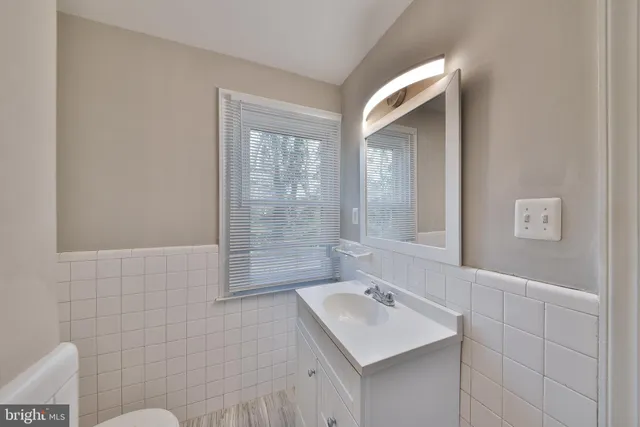a bathroom with a sink mirror and a bathtub