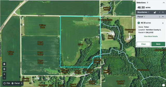 a green field with lots of trees