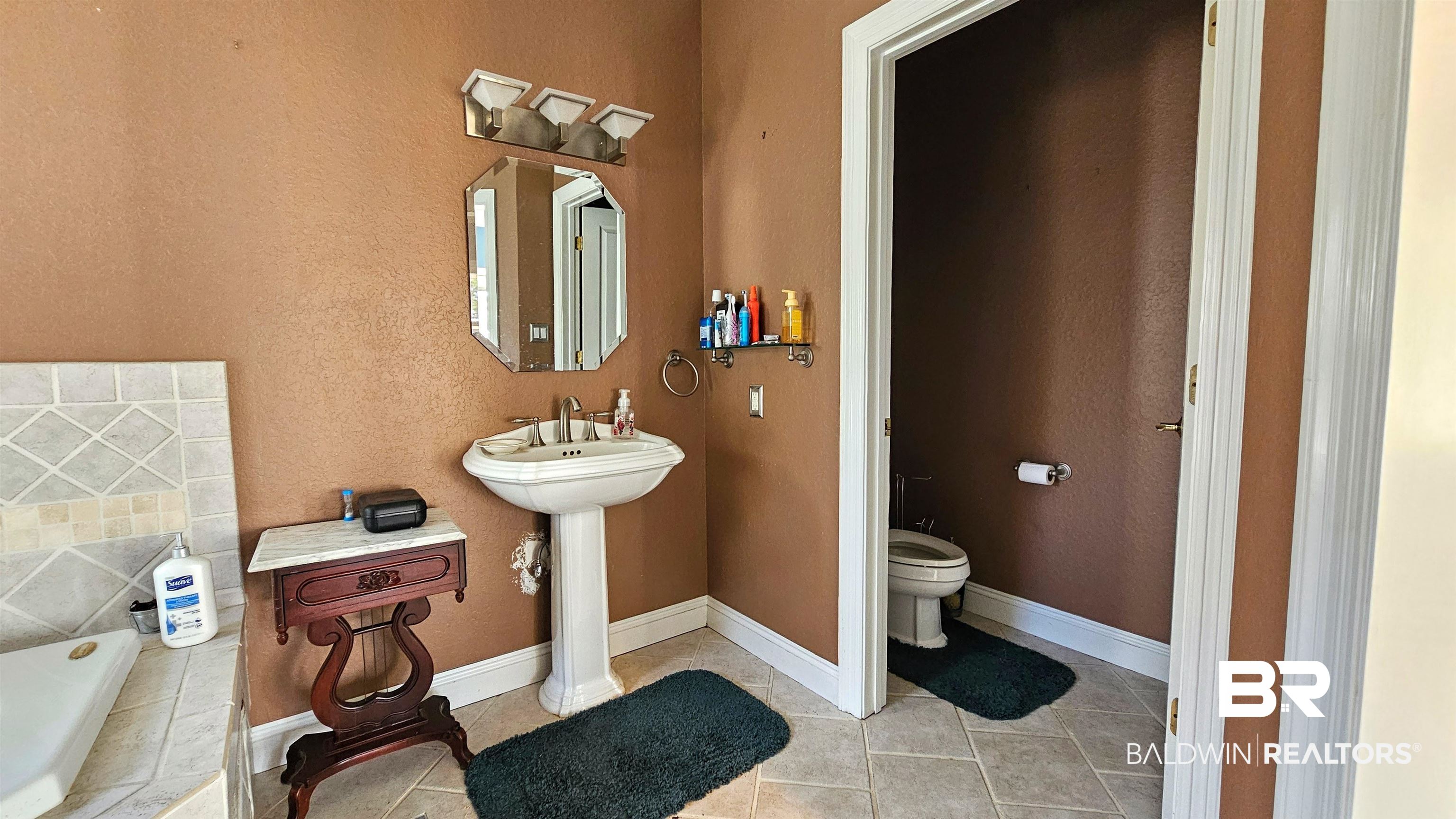 9275 Crawford Road Elberta, AL 36530 - Photo 16 of 28 Bathroom with toilet and light tile patterned floors