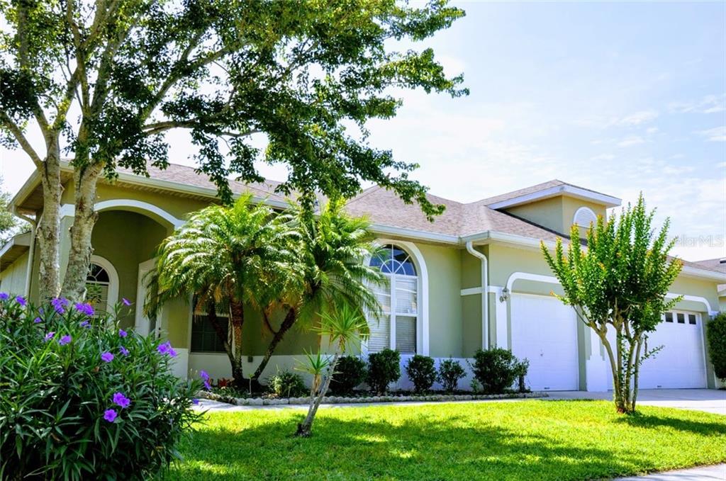 13839 Amberleigh Road Orlando, FL 32837 - Photo 1 of 1 a front view of a house with a garden