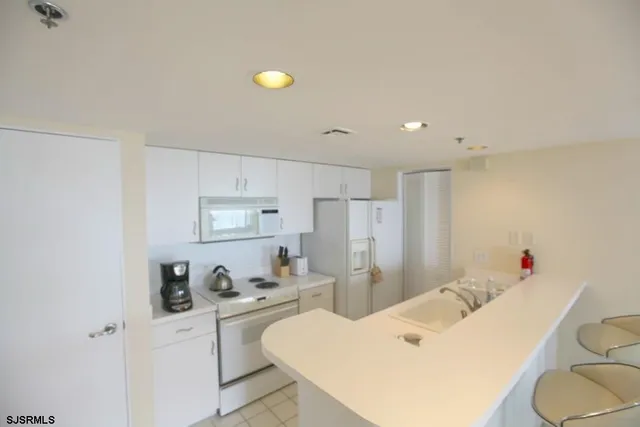 a kitchen with a sink appliances and cabinets
