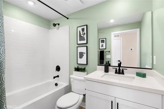 a bedroom with a bed and a potted plant