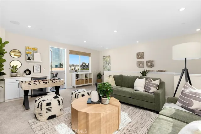 a kitchen with stainless steel appliances a dining table chairs and white cabinets
