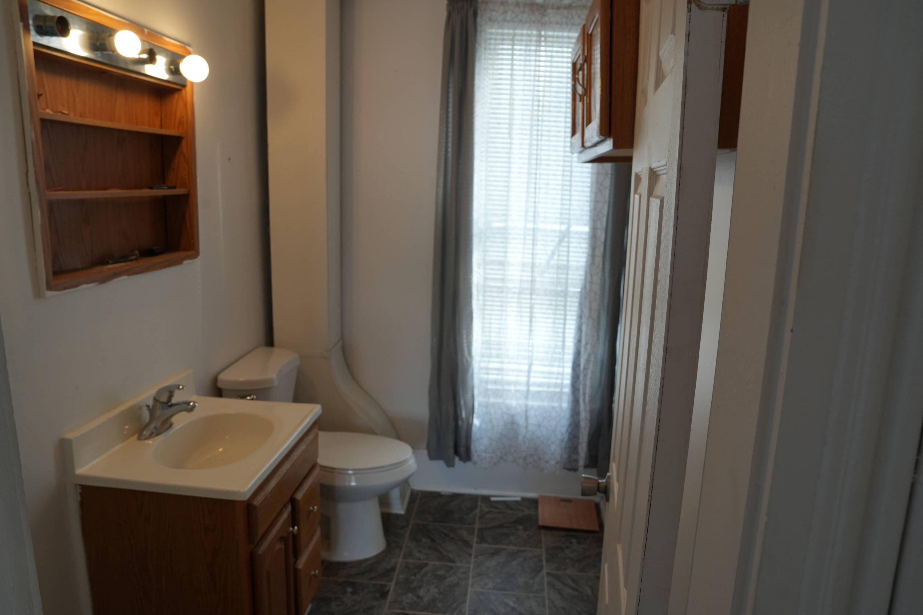 1002 Franklin Avenue Rochester, IN 46975 - Photo 12 of 15 a bathroom with a sink toilet and vanity