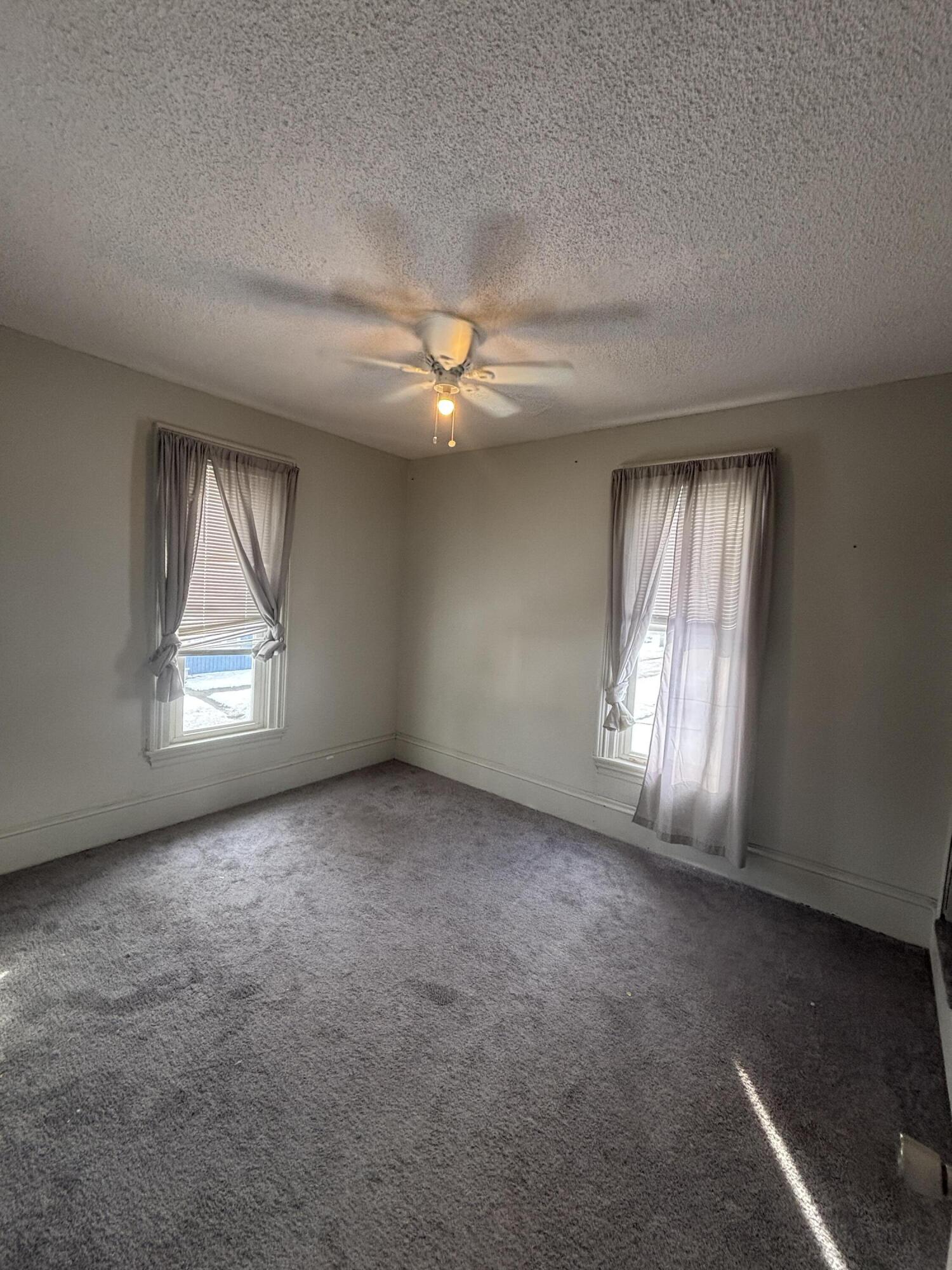 1002 Franklin Avenue Rochester, IN 46975 - Photo 13 of 15 an empty room with windows and fan