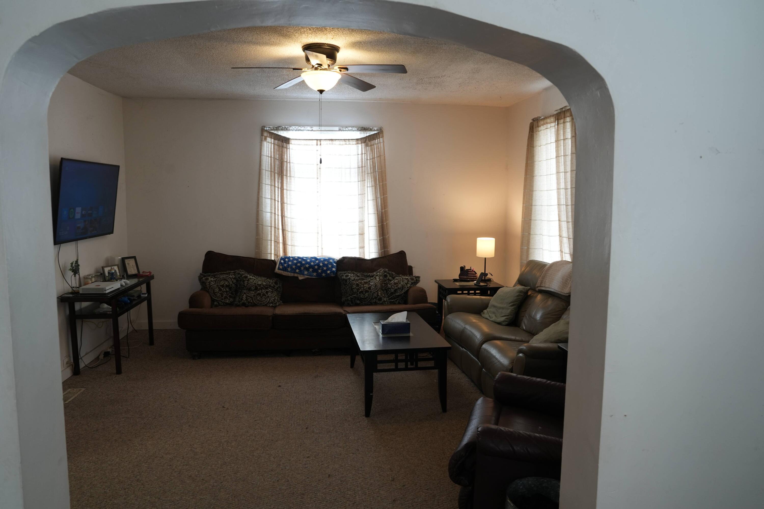 1002 Franklin Avenue Rochester, IN 46975 - Photo 3 of 15 a living room with furniture a chandelier and a window