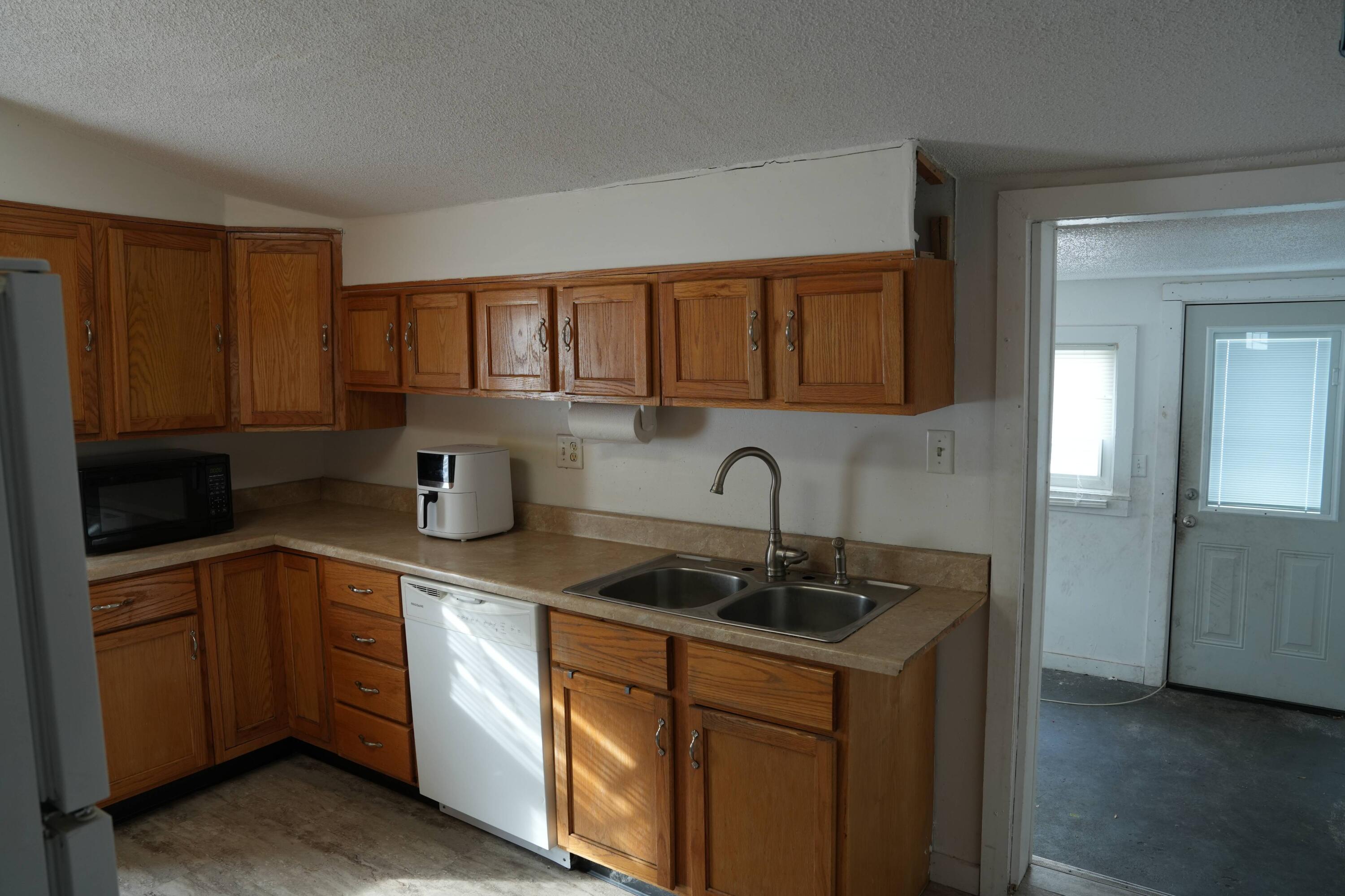 1002 Franklin Avenue Rochester, IN 46975 - Photo 7 of 15 a kitchen with stainless steel appliances granite countertop a sink stove and cabinets