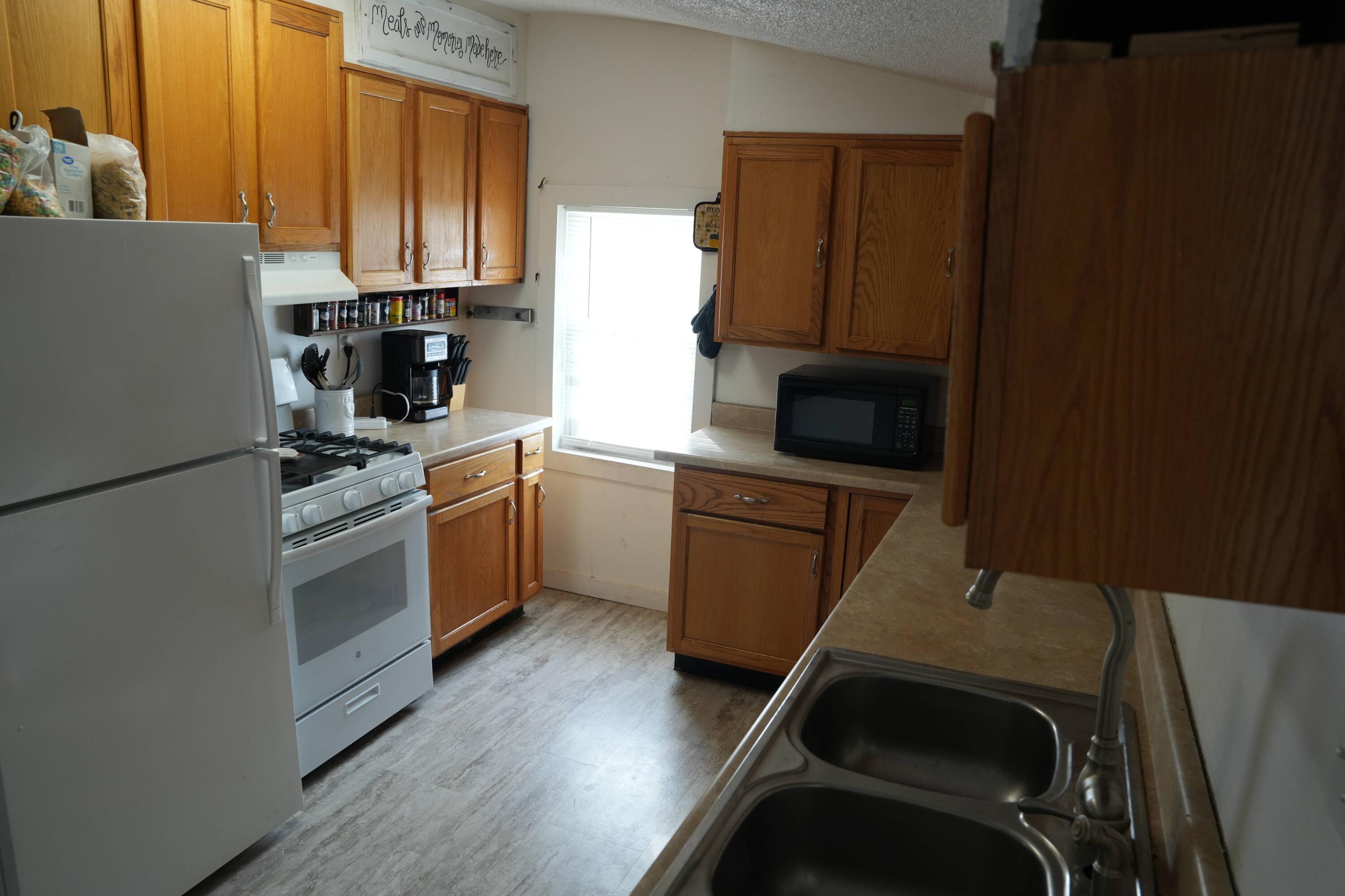 1002 Franklin Avenue Rochester, IN 46975 - Photo 8 of 15 a kitchen with a refrigerator sink and cabinets