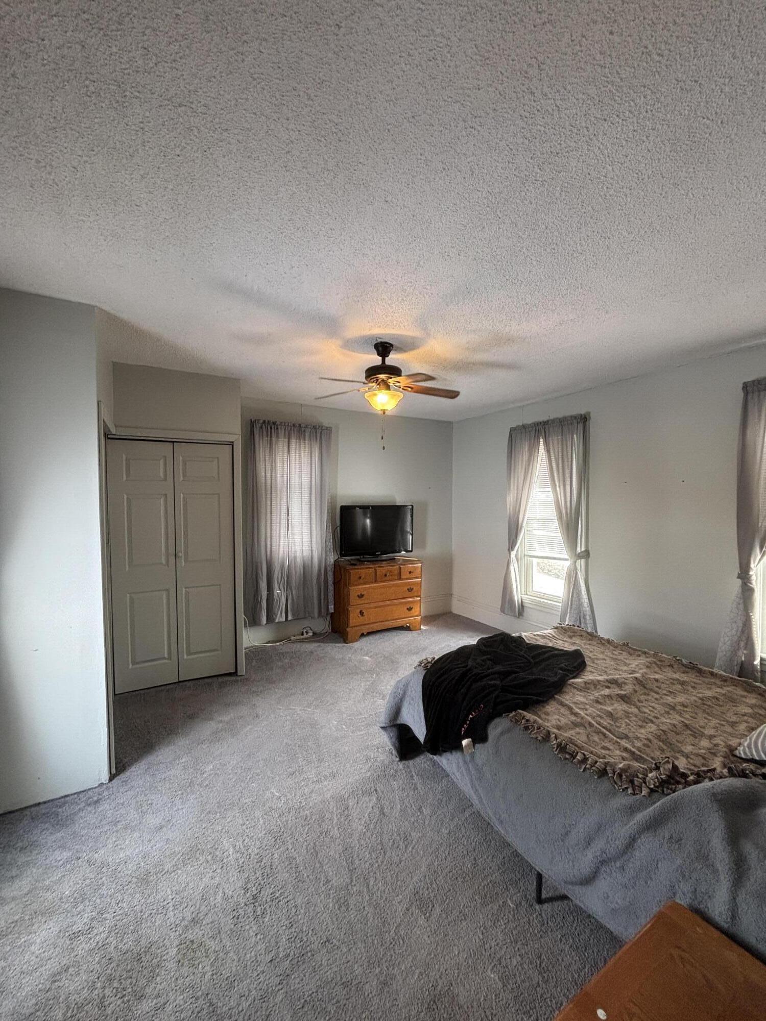 1002 Franklin Avenue Rochester, IN 46975 - Photo 10 of 15 a bedroom with a bed and a chandelier