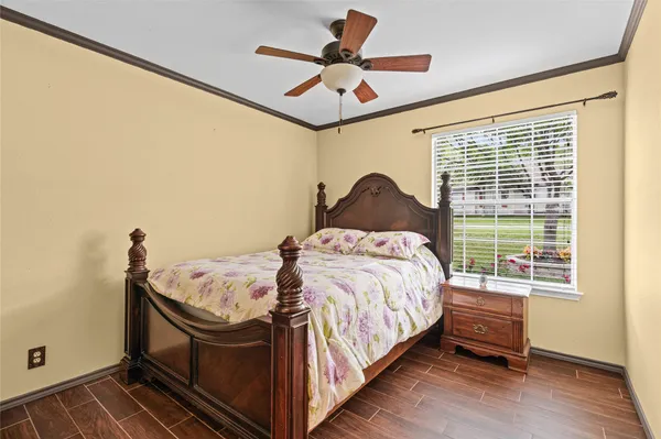 a bed sitting in a bedroom next to a window
