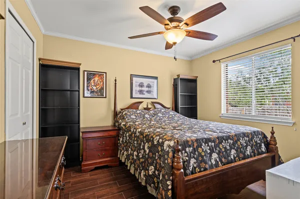 a bedroom with a large bed and a chandelier
