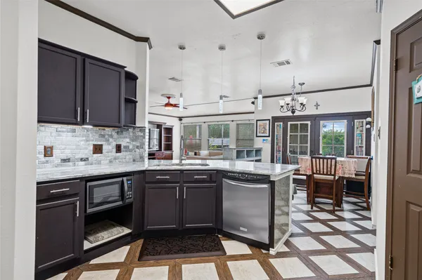 a open kitchen with stainless steel appliances granite countertop a sink and cabinets