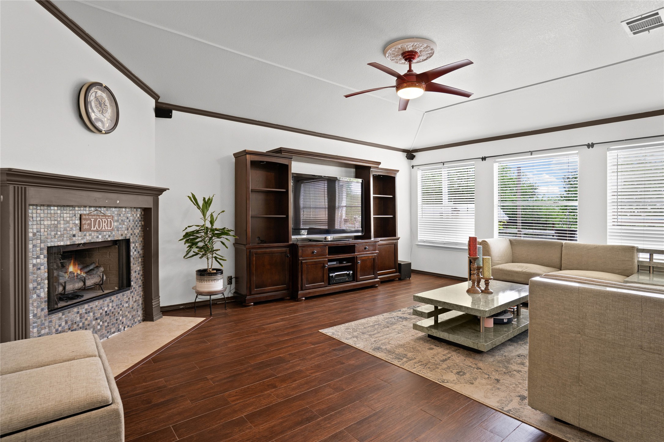 315 Appleton Court Buda, TX 78610 - Photo 5 of 28 a living room with furniture a flat screen tv and a fireplace