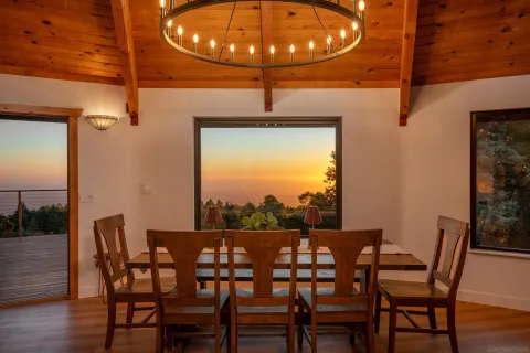 a dining room with furniture and wooden floor