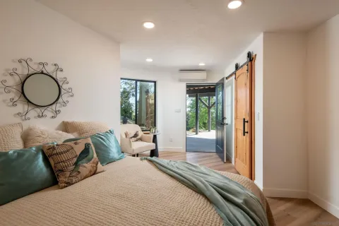 a bedroom with a large bed and a large window