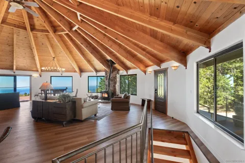 a living room with furniture and large windows