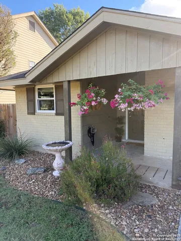 a front view of house with flowers