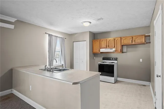 a kitchen with a sink cabinets and window