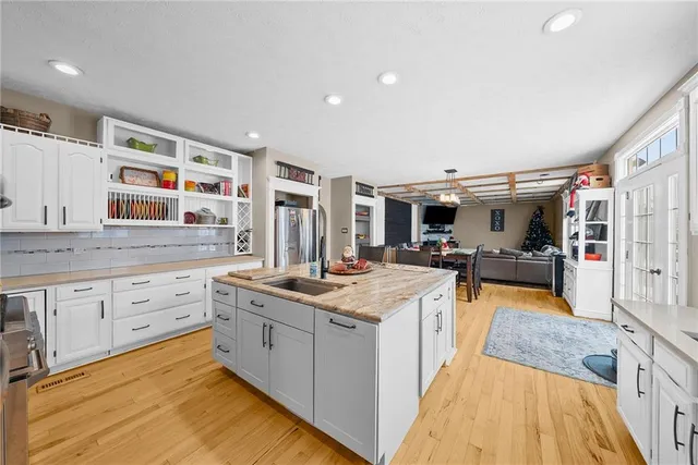 a kitchen with stainless steel appliances granite countertop a stove and cabinets