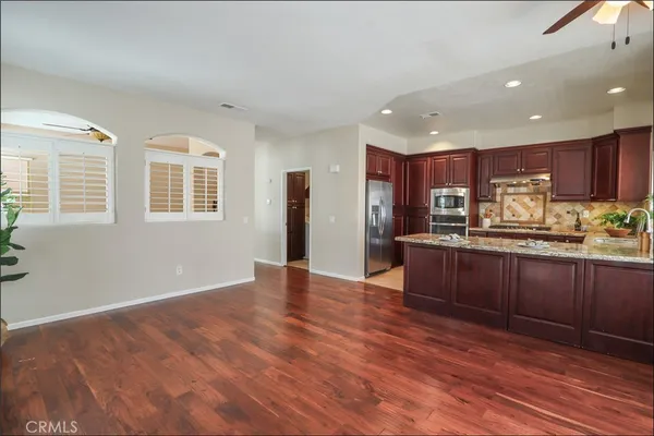 a kitchen with stainless steel appliances granite countertop a stove a sink and a microwave