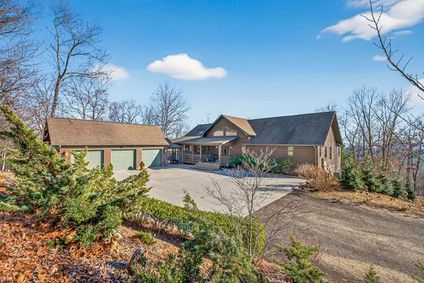 a living room with furniture large window and wooden floor