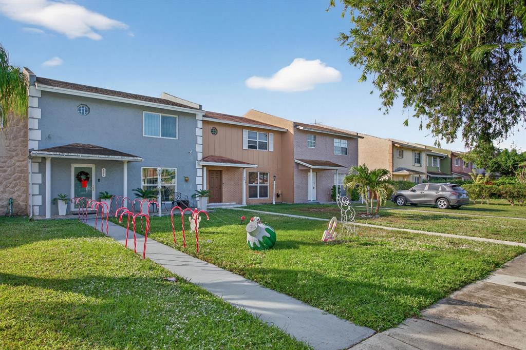 6224 Southwest 7th Street Margate, FL 33068 - Photo 11 of 51 a front view of a house with a yard table and chairs