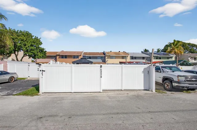 a view of a cars park in front of a house