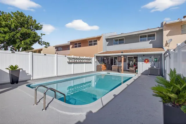 a view of an outdoor dining space with a table and chairs