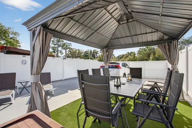 a view of a patio with table and chairs