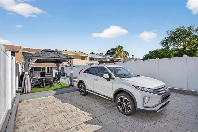 a living room with furniture ceiling fan and a window