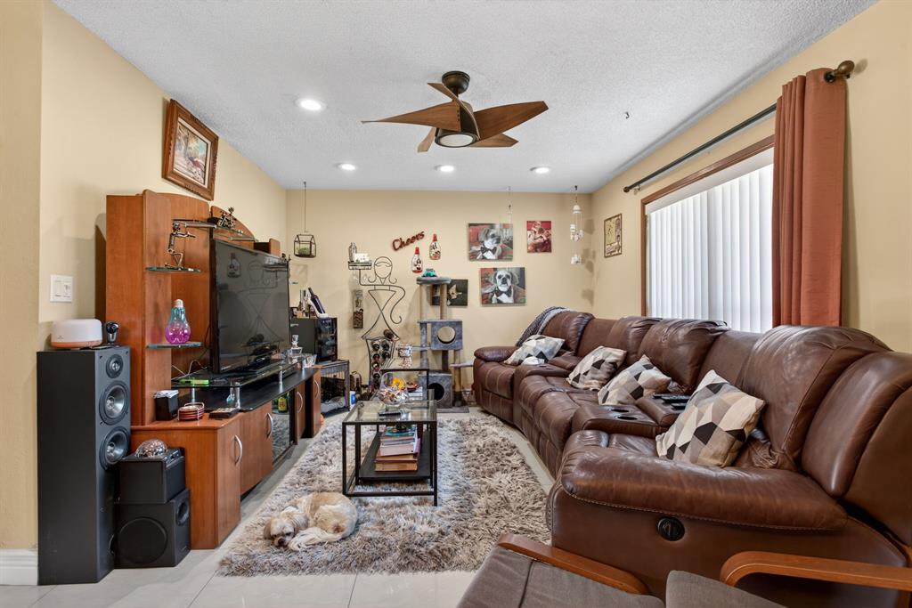6224 Southwest 7th Street Margate, FL 33068 - Photo 22 of 51 a living room with furniture ceiling fan and a window