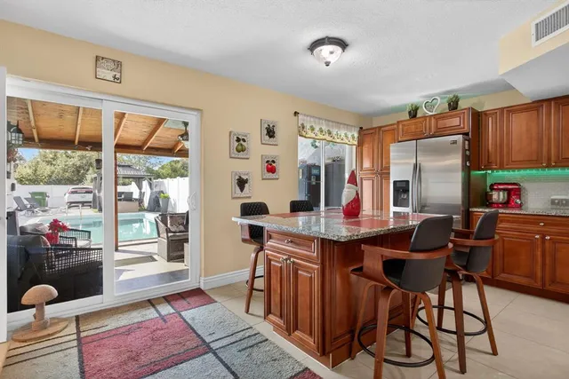 a kitchen with a sink a counter top space cabinets and stainless steel appliances