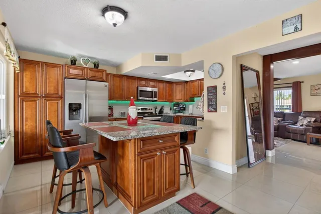 a kitchen with stainless steel appliances granite countertop a sink stove microwave and cabinets