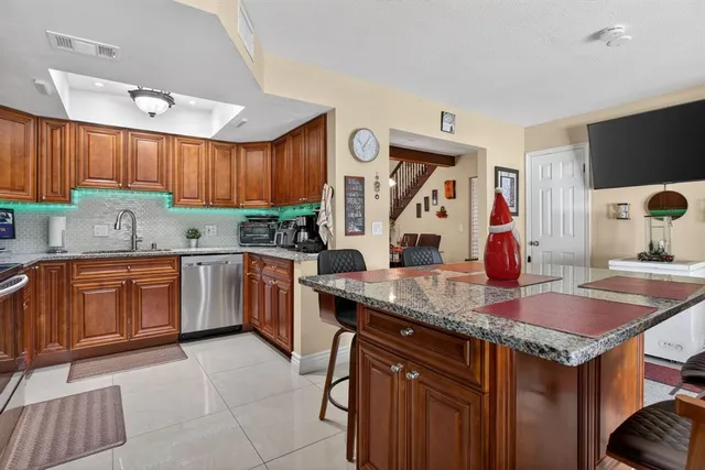 a kitchen with stainless steel appliances granite countertop a sink stove and microwave
