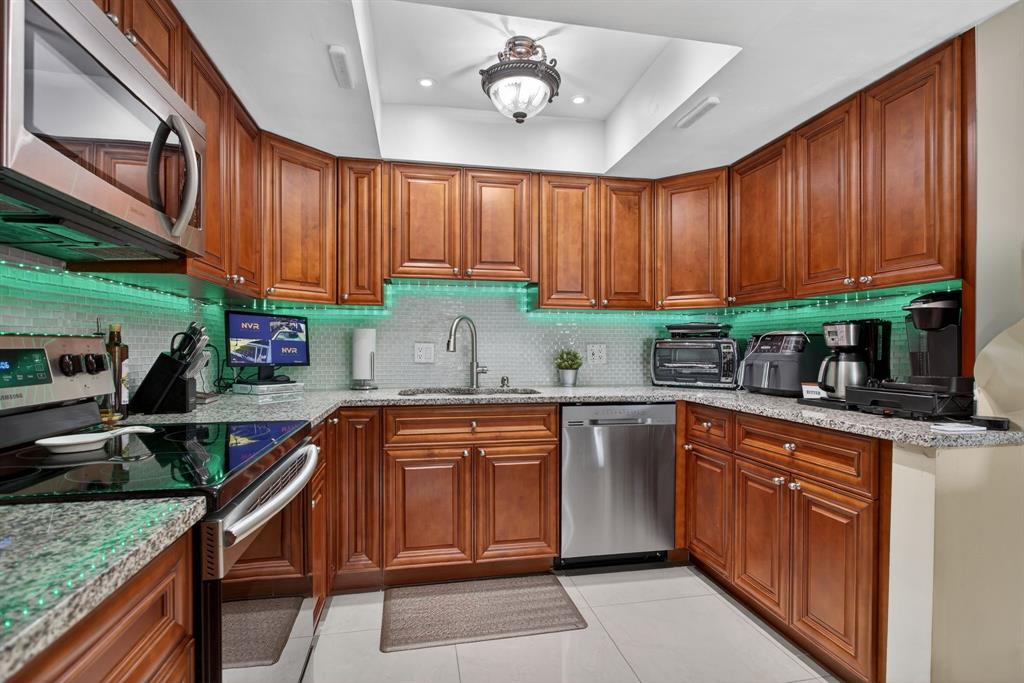6224 Southwest 7th Street Margate, FL 33068 - Photo 31 of 51 a kitchen with stainless steel appliances granite countertop a sink stove microwave and cabinets