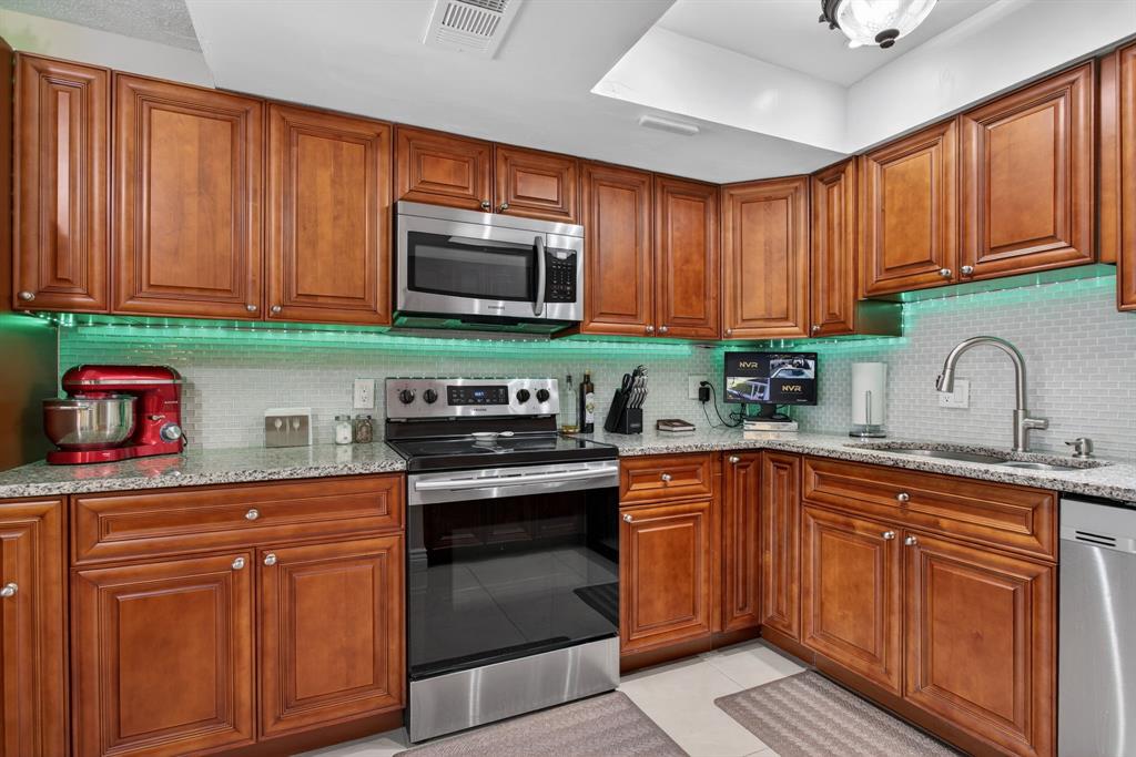 6224 Southwest 7th Street Margate, FL 33068 - Photo 32 of 51 a kitchen with stainless steel appliances granite countertop a sink stove and microwave