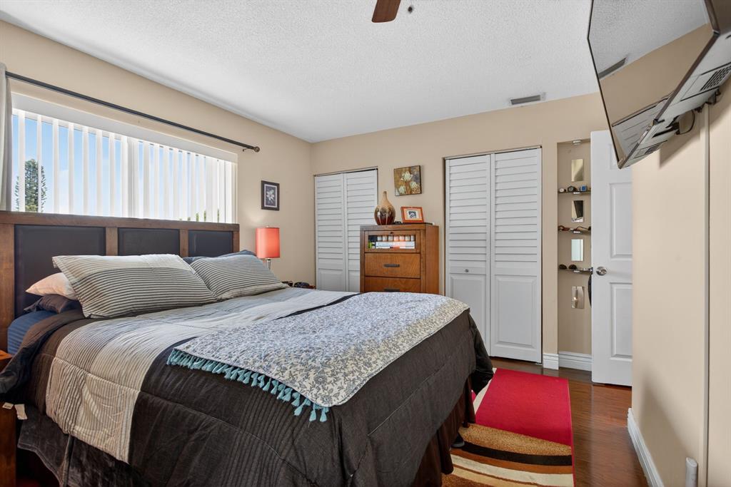 6224 Southwest 7th Street Margate, FL 33068 - Photo 38 of 51 a bedroom with a bed and wooden floor