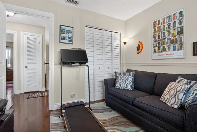 an aerial view of residential houses with outdoor space and trees