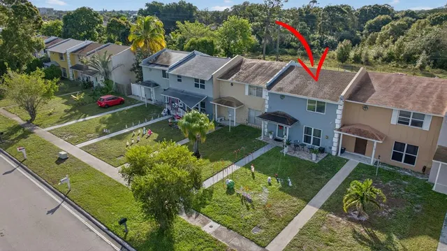 an aerial view of residential houses with outdoor space