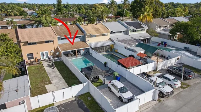 an aerial view of multiple houses with yard