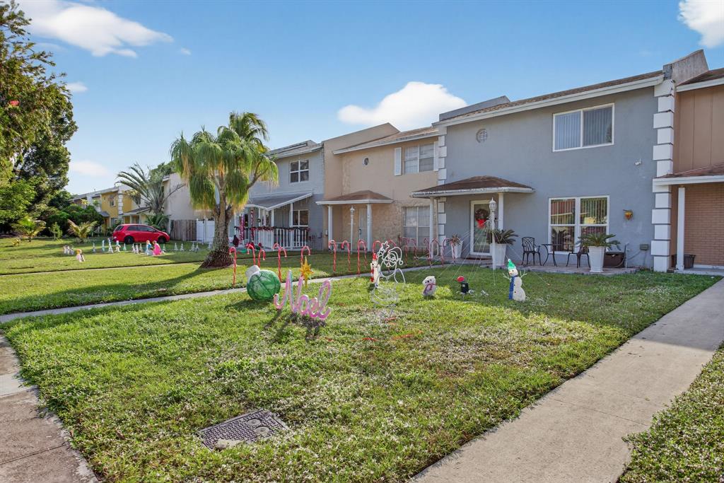 6224 Southwest 7th Street Margate, FL 33068 - Photo 10 of 51 a front view of a house with a garden and trees