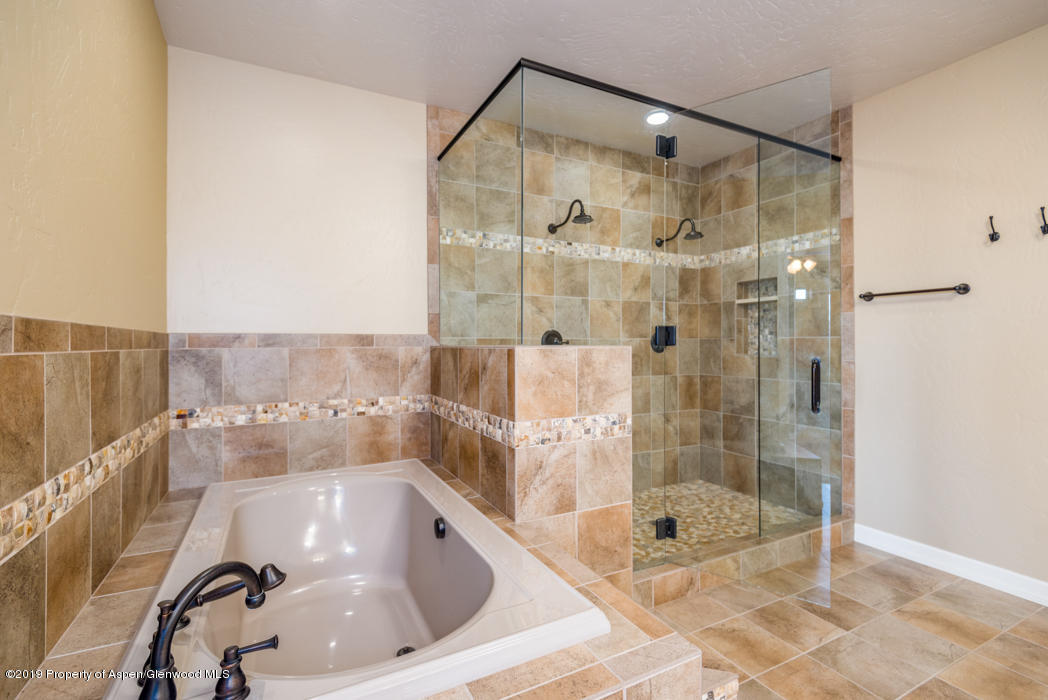 1317 East 17th Street Rifle, CO 81650 - Photo 20 of 57 a bathroom with a bathtub and a shower