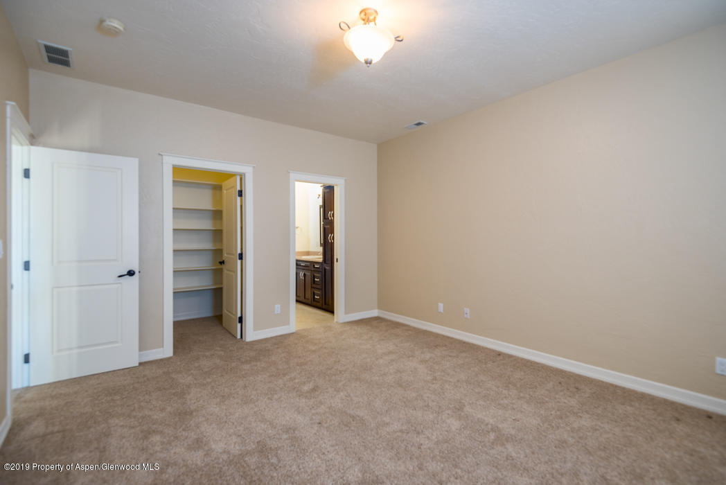 1317 East 17th Street Rifle, CO 81650 - Photo 24 of 57 an empty room with closet and a chandelier fan