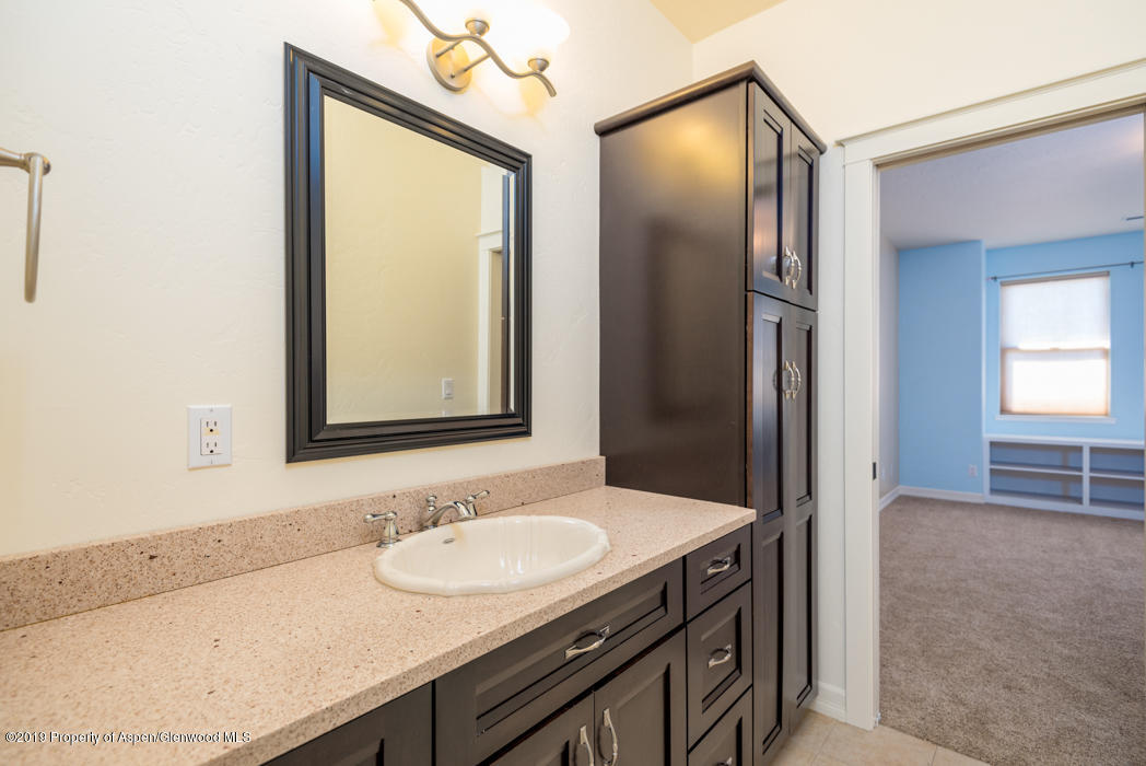 1317 East 17th Street Rifle, CO 81650 - Photo 25 of 57 a bathroom with a sink and a mirror