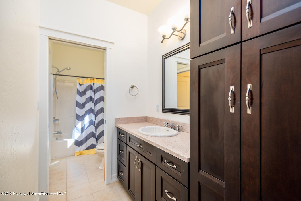 1317 East 17th Street Rifle, CO 81650 - Photo 26 of 57 a bathroom with a granite countertop shower and a sink