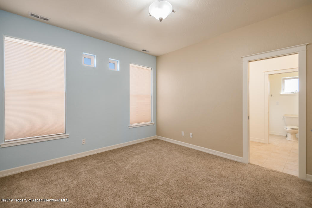 1317 East 17th Street Rifle, CO 81650 - Photo 28 of 57 an empty room with windows and closet